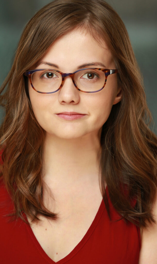 Headshot of Tal Anderson, Actor in her 20's, wearing a sleeveless blouse and glasses.